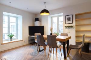 a dining room with a table and chairs at Pilies Street Exclusive Apartment by Reside Baltic in Vilnius