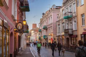 a group of people walking down a street at Pilies Street Exclusive Apartment by Reside Baltic in Vilnius