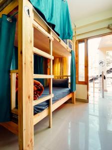 a room with bunk beds in a house at Backpackers Headquarter Manali in Manāli