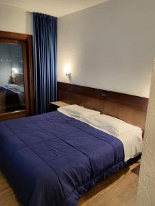 Una cama o camas en una habitación de Hotel Miage