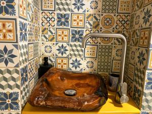 a bathroom with a wooden sink with a faucet at The House a la Cluj in Cluj-Napoca