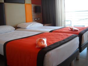 two beds in a hotel room with plastic bags on them at Hotel Tiber in Fiumicino