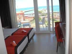 a hotel room with two beds and a view of the ocean at Hotel Tiber in Fiumicino