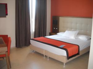 a bedroom with a large bed in a room at Hotel Tiber in Fiumicino