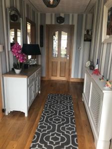 a hallway with a door and a rug at Seacrest in Galway