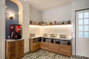 a kitchen with a counter with a tv and shelves at O Pierre in Panaji