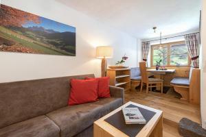 a living room with a couch and a table at Oberglarzhof App Zirbel in Villnoss