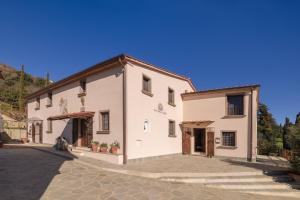 a large white building on a cobblestone street at Rivo della Corte in Pistoia