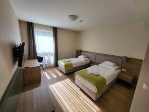 a hotel room with two beds and a television at D50 Hotel in Budapest