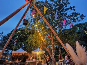 a group of people sitting at tables under tents at DOX Ko Lanta in Ko Lanta