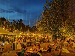 a group of people sitting at tables in a market at night at DOX Ko Lanta in Ko Lanta