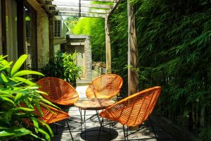 a group of chairs and a table on a patio at Chanteak Bali in Jimbaran