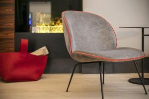 a chair and a red bag in a room at Boutique Hotel Das Tigra in Vienna