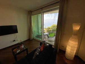 a living room with a couch and a sliding glass door at Emma in Verbania