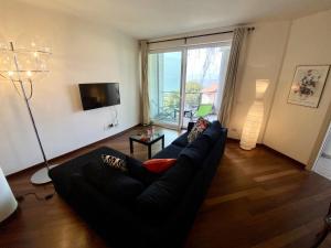 a living room with a couch and a large window at Emma in Verbania