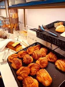 croissants en andere gebak op een toonbank bij Hostellerie Cèdre & Spa Beaune in Beaune