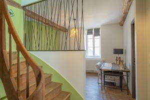 a hallway with a staircase and a table in a room at Charmes en Chambertin in Gevrey-Chambertin