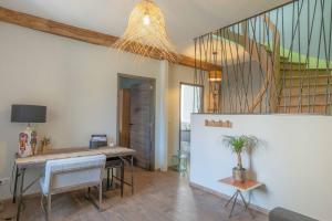 a living room with a table and a staircase at Charmes en Chambertin in Gevrey-Chambertin