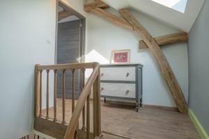 a wooden staircase in a room with wooden beams at Charmes en Chambertin in Gevrey-Chambertin