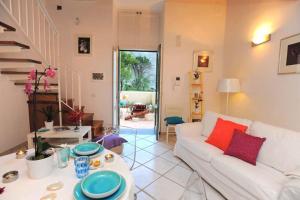 a living room with a white couch and a table at Loft Apartments by AMALFIVACATION in Amalfi