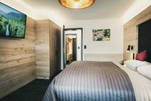 a bedroom with a large bed and a tv at Hotel Koch in Bad Liebenzell