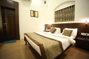 a bedroom with a large bed in a room at The Byke Heritage Adventure Park & Resort, Matheran in Matheran