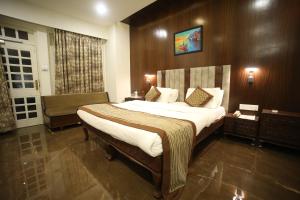 a bedroom with a large bed in a room at The Byke Heritage Adventure Park & Resort, Matheran in Matheran