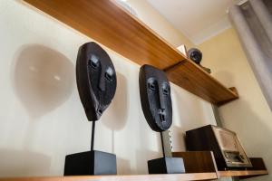 two black speakers on a wall next to a microwave at Green House - Douro in Peso da Régua