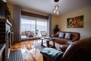 a living room with a couch and a table at Green House - Douro in Peso da Régua