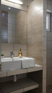 a bathroom with a sink and a mirror at Teke Bowling Centrum és Sport Panzió in Szeged