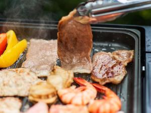 箱根Rakuten STAY VILLA Hakone Sengokuhara South Wing 103 BBQ Terrace capacity of 10 persons的烤架上放有肉、虾和蔬菜