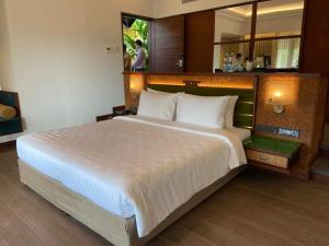 a bedroom with a large white bed in a room at Great Trails Wayanad by GRT Hotels in Wayanad