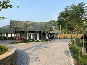 a large house with a driveway in front of it at Great Trails Wayanad by GRT Hotels in Wayanad