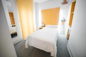 a bedroom with a white bed in a room at Hostal Albany in León