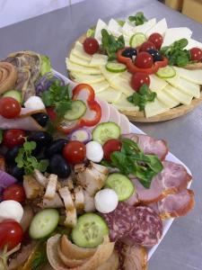 deux plaques remplies de différents types de denrées alimentaires sur une table dans l'établissement Pensiunea LUKA Slanic Moldova, à Slănic-Moldova