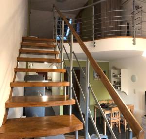 a staircase in a house with wooden stairs and a ceiling at Pitypang Apartman in Gyula