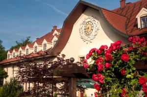 a house with red roses in front of it at Turówka Hotel & Spa in Wieliczka