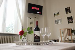 a bottle of wine sitting on a table with two wine glasses at Il Giardino Del Pettirosso in Lucca