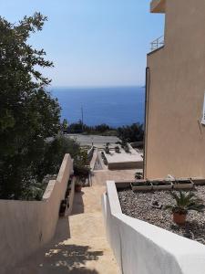 a view of a building with the ocean in the background at Apartmani NIKA in Dubrovnik