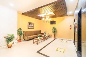 a living room with a couch and a table at Octave Himalaya Monarch in Bangalore