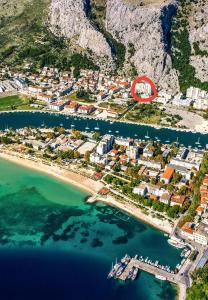 an aerial view of a beach with a red circle at Apartman Nela in Omiš