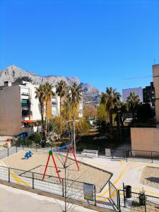 a playground in a park with palm trees at Apartman Nela in Omiš