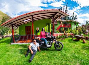 een man op een motor voor een huis bij Happy Land Valle Sagrado in Urubamba