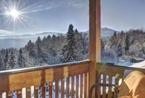 a balcony with a view of the snow covered trees at Hotel Brunnenhof in Bayerisch Eisenstein