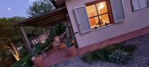 a house with a window with a person sitting in it at La Mandorla Salata in Capoliveri