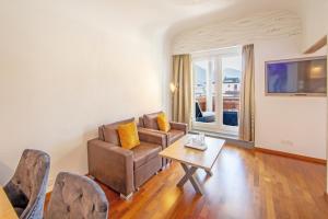 a living room with a couch and a table at Hotel Europe in Davos