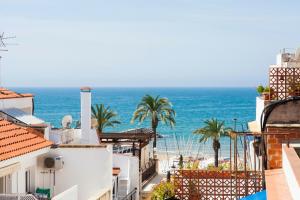 a view of the ocean from the roofs of buildings at Kare No Apartments by Sitges Group in Sitges