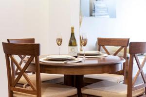 a dining room table with two glasses of wine at De Lux Apartments Sirena in Kotor