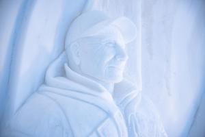 a statue of a man looking out a window at Sorrisniva Igloo Hotel in Alta