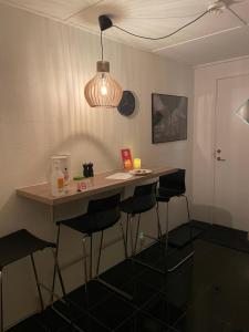 a kitchen with a table and stools in a room at Helts B&B - Helts Guesthouse in Herning